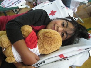 050610 Priscila Marquez hugs her Red Cross teddy bear at shelter in Memphis